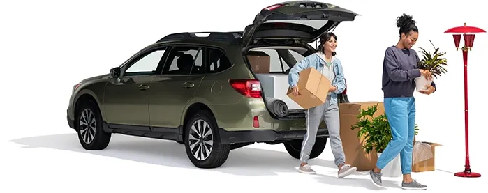 A mother and daughter remove household items from their SUV.